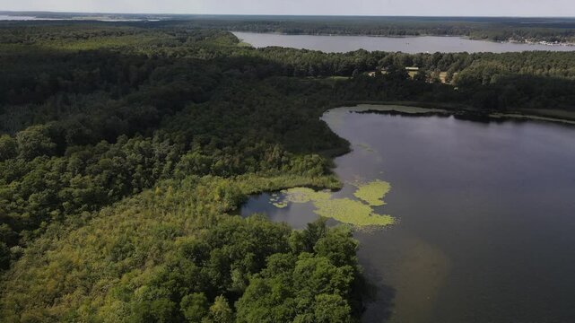 Fly over green nature and lake at the K&ouml;lpingsee area which is close located to Jabel