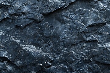 Dark gray texture of rough natural stone surface. Background of fragment of mountain close up.