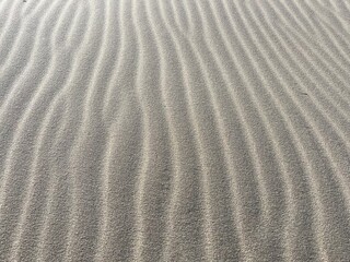 Beach sand wave pattern created by wind and waves