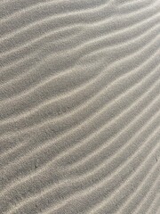 Beach sand wave pattern created by wind and waves
