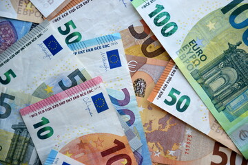 Many european euro money bills in chaotic arrangement. Pile of eur banknotes with different colors and condition