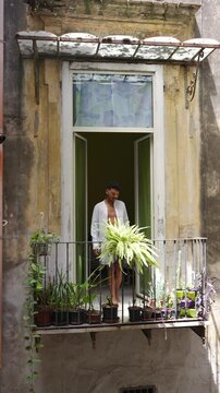 Man Standing on Traditional Balcony in Naples Italy
