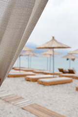 Borsh,Albania, July 10,2024:nside a beach bar, looking from inside the bar to the beautiful beach 