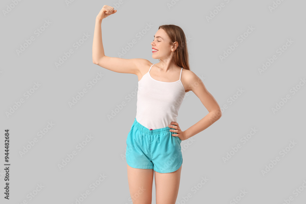 Sticker Sporty young woman on grey background