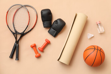 Set of sports equipment on beige background
