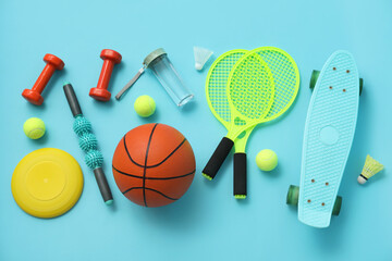 Set of sports equipment on blue background, top view