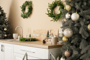 Christmas tree with balls in kitchen, closeup