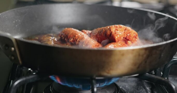 Mexican chorizo cooking on gas stove 