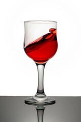 Red wine swirling into glass