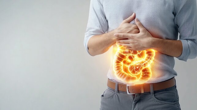An image of a person holding their stomach in pain while at a social event, with an overlay showing inflamed intestines Inflammatory bowel disease IBD concept.