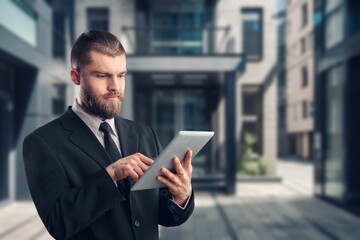 Focused successful businessman with digital tablet