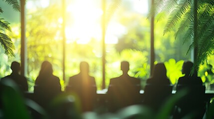 Group, boardroom and business meeting in an office for collaboration, teamwork and sustainability. Blurry, green and silhouette people sitting together for meeting and leadership in nature workplace