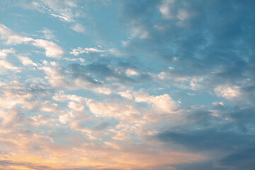 Sky is blue with a few clouds in the morning. The clouds are white and scattered. The sky is very clear and bright