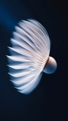 White Feather Shuttlecock in Flight Against a Dark Background