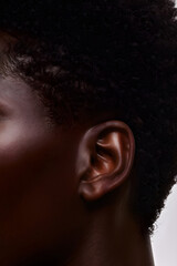 Close view of an African woman&rsquo;s ear with textured hair