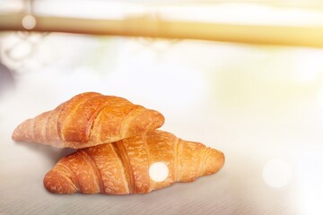 Freshly baked tasty croissant on the desk