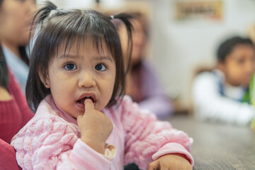 Little girl impatiently waiting for dessert in restaurant