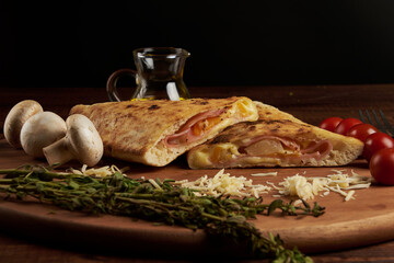 Calzone, traditional Italian preparation accompanied by spices and red wine