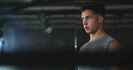 Man, looking and dumbbell for workout in gym with arms, weights and training for strength. Male person, discipline and fitness routine with determination on face for physical, wellness and health