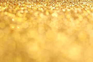 Beautiful shiny golden glitter as background, closeup