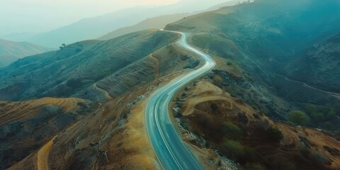 Aerial view of winding mountain road captured by drone