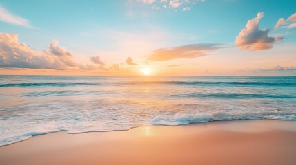 Fototapeta premium Sunset over calm ocean waves at a serene beach during early evening with soft clouds in the sky