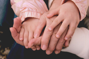 Grandmother and granddaughter holding hands together. Support, love, care and togetherness. Praying, vitality. Grandparents Day