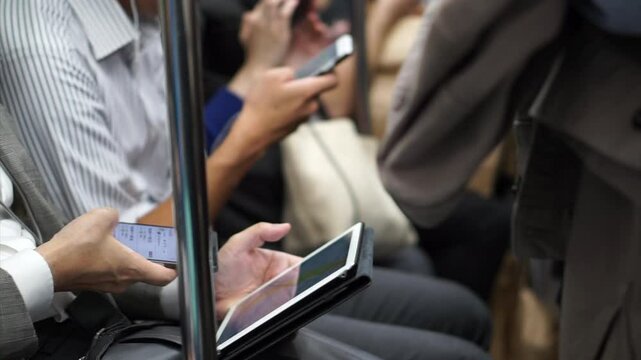 No face Asian passengers using smartphone in train public transportation after working overtime
