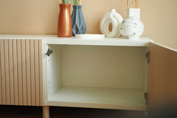A modern minimalist cabinet that complements decorative vases for a stunning aesthetic appeal