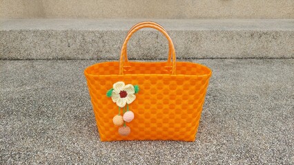 Orange woven basket on concrete floor