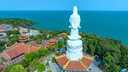 Fototapeta premium Aerial view of Ho Quoc pagoda in Phu Quoc island, Kien Giang, Vietnam, with Guan Yin statue overlooking the sea blessing the islanders with peace and happiness