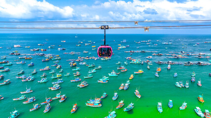 The longest cable car ride in the world, Phu Quoc island in South Vietnam. Below is traditional fishermen boats lined in the harbor of An Thoi town in the popular Hon Thom island. © huythoai
