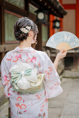 Japanese Kimono back view with Japanese traditional buildings background. Kyoto, Japan. 