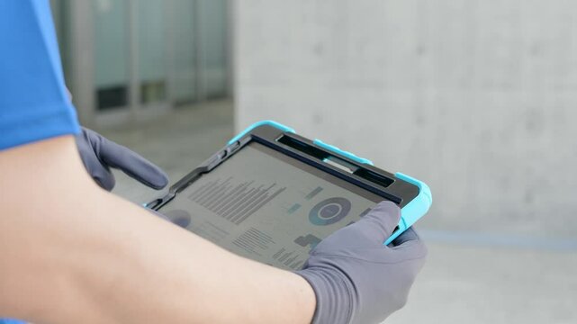 Workers consulting while looking at a tablet PC
