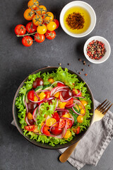 Easy vegetarian salad of fresh cucumber, tomato, sweet pepper, radish and onion . Healthy food. Top view
