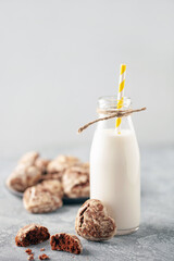 Classic chocolate heart gingerbread in sugar icing. Gingerbread and milk on the table.