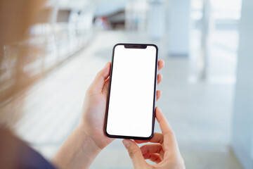 Hand holding smartphone mockup of blank screen, Take your screen to put on advertising.