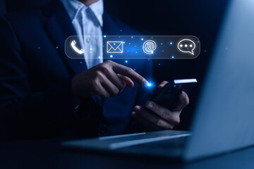 Businessman using laptop with icons of contact us or contact customer, customer support, contact us or customer support hotline(email, call, mail), customer service, contact concept