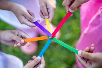 A group of children holding sticks together in a circle
