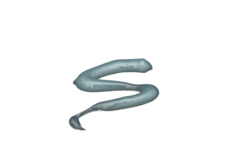 Toothpaste in the form of a blue zigzag lies on a transparent background.
