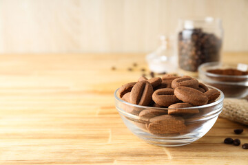Cookies in the shape of coffee beans in transparent bowls