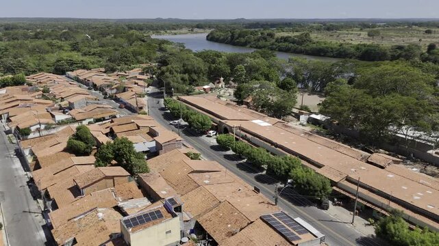 Drone flies backwards low over houses next to Poti River in Teresina, Piau&iacute;, Brazil