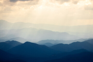 Landscape of Morning Mist with Mountain Layer at north of Thailand. mountain ridge and clouds in rural jungle bush forest