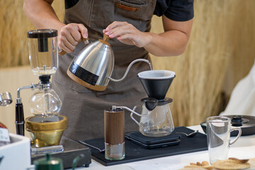 barista is preparing equipment for making coffee.
