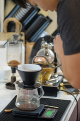 barista is preparing equipment for making coffee.
