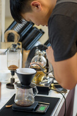 barista is preparing equipment for making coffee.
