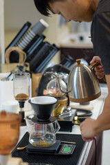 barista is preparing equipment for making coffee.