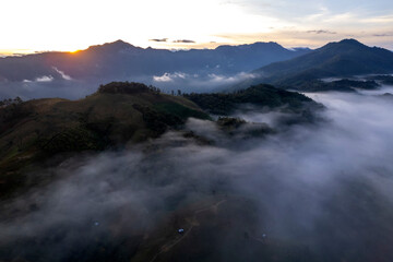 Landscape of Morning Mist with Mountain Layer at north of Thailand. mountain ridge and clouds in rural jungle bush forest