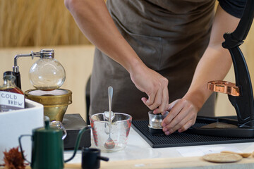 barista is preparing equipment for making coffee.