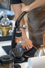 barista is preparing equipment for making coffee.